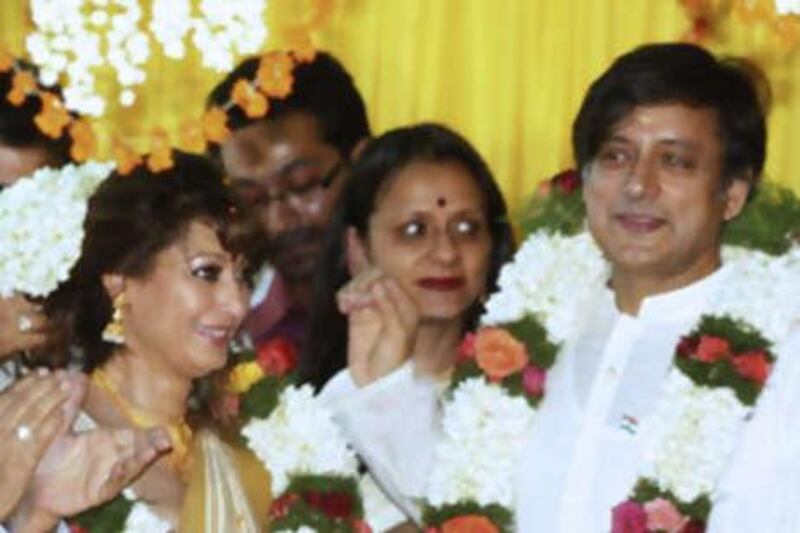Indian parliamentarian Shashi Tharoor (R) and his bride Sunanda Pushkar Sunday (L) take part in their wedding ceremony in Pallakad on August 22, 2010.  Former UN diplomat Shashi Tharoor married long-time friend Sunanda Pushkar Sunday, months after the couple were the focus of a cricket team ownership scandal that saw him quit the Indian government. The couple were married in the presence of close relatives in Tharoor's ancestral home in the southern state of Kerala, a witness said.  AFP PHOTO/STR

