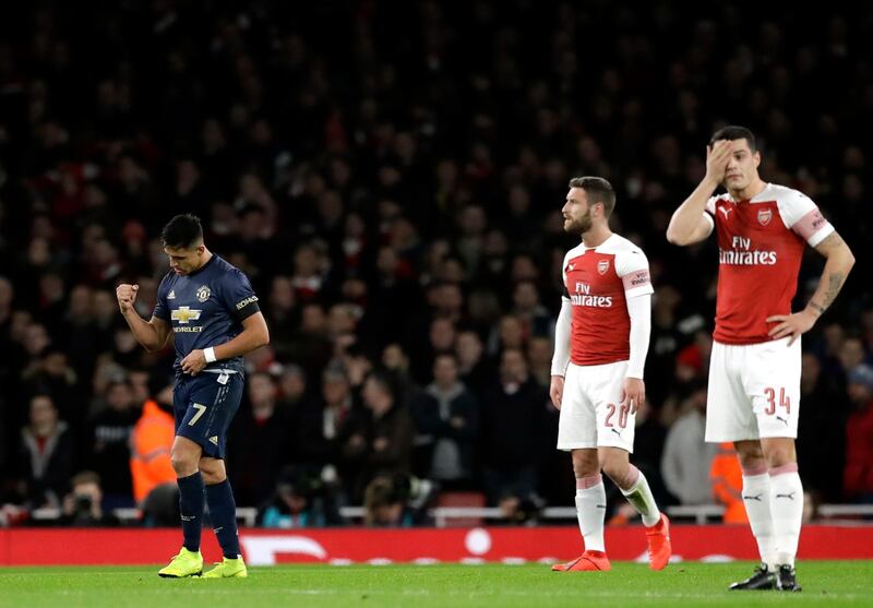 Manchester United's Alexis Sanchez, left, celebrates after scoring his side's opening goal during the English FA Cup fourth round soccer match between Arsenal and Manchester United at the Emirates stadium in London, Friday, Jan. 25, 2019. (AP Photo/Matt Dunham)