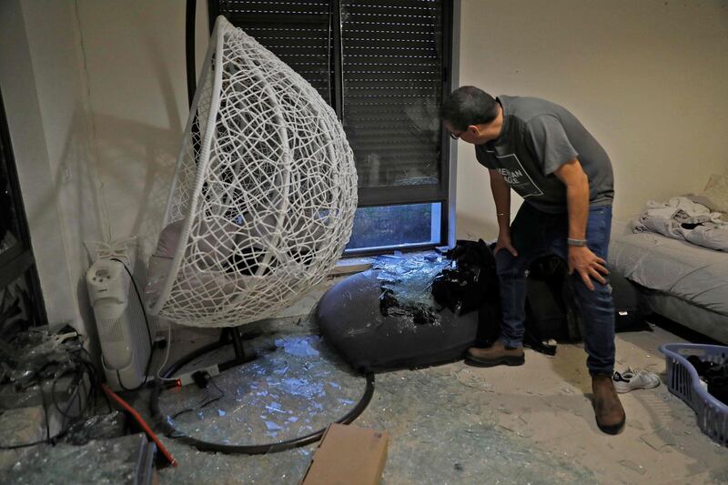 An Israeli man checks debris at a house on the outskirts of Jerusalem, where a rocket fired from the Gaza Strip fell. AFP