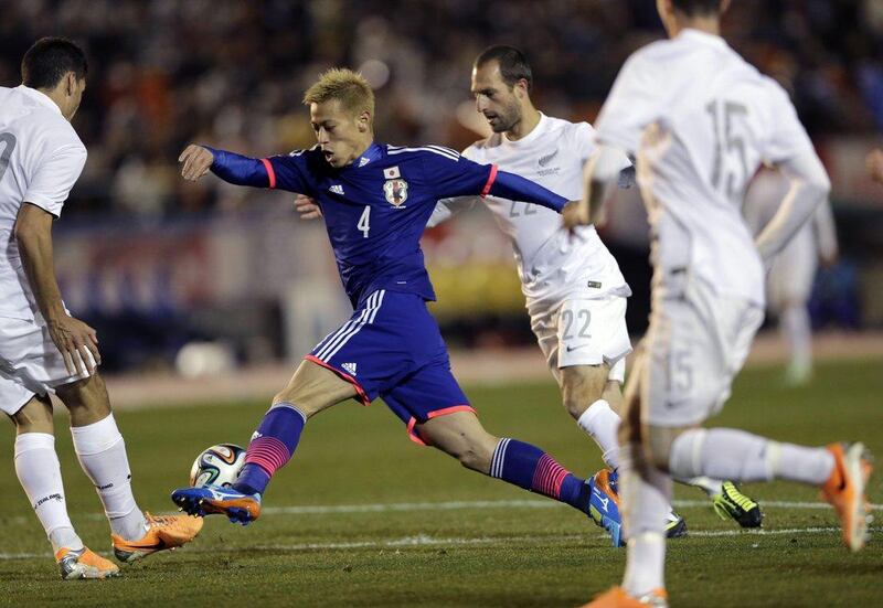 Keisuke Honda and Japan beat New Zealand 4-2. They'll play in Group C at the 2014 World Cup with Colombia, Greece and Ivory Coast. Shuji Kajiyama / AP