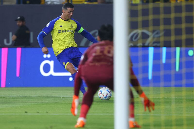 Cristiano Ronaldo attempts a shot against Shabab's South Korean goalkeeper Kim Seung-gyu. AFP