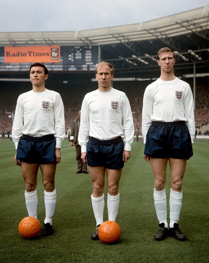 Brothers Bobby Charlton (centre) of Manchester United and Jackie Charlton of Leeds United (right) on the field at Wembley Stadium in 1965. PA