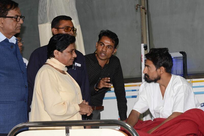 The chief of the Bahujan Samaj Party, Mayawati (second from left) visits Vashrambhai Sarvaiya (right), one of four Dalit youths who were badly beaten by cow protectors in the Una region of Gujarat, at the Civil hospital in Ahmedabad on August 4, 2016. Sam Panthaky/AFP

