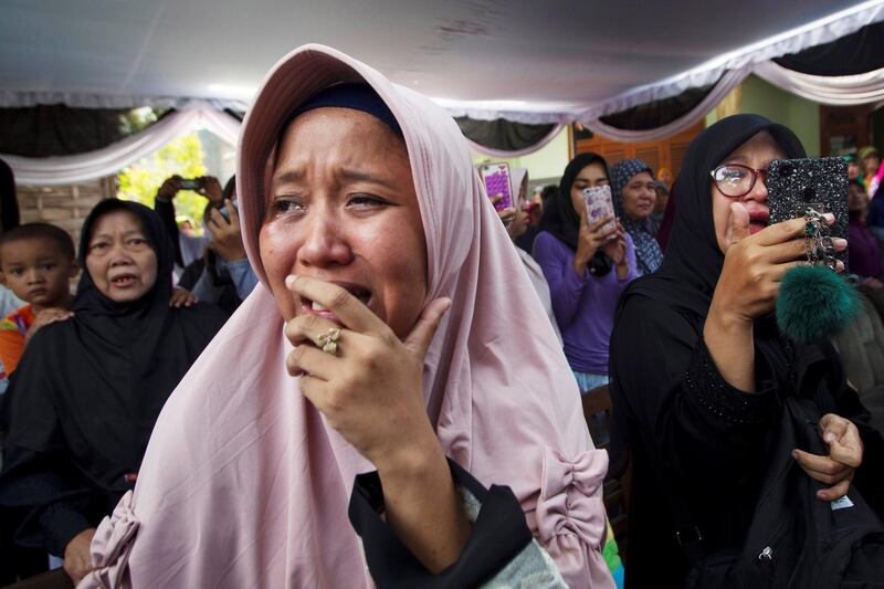 A family cries during funeral of of one of the passengers at Sukodono village in Sidoarjo. Reuters