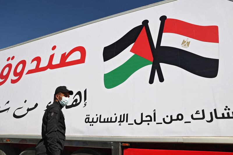 A member of Palestinian security forces stands by an Egyptian aid lorry arriving at the Rafah border crossing. AFP