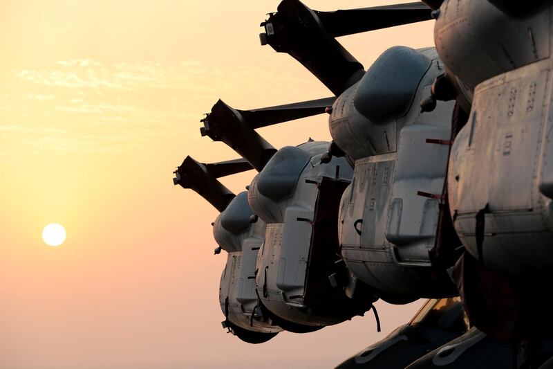 Wings of MV-22 Osprey aircrafts are seen during sunset.