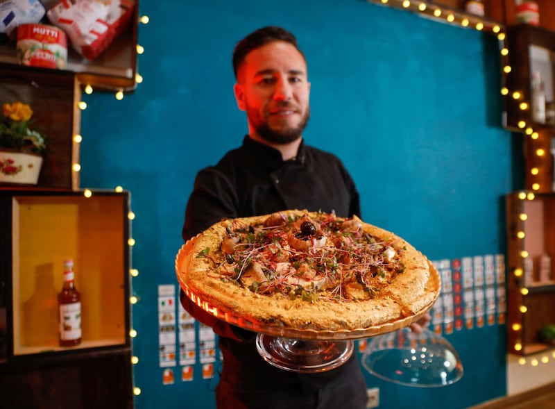 Ahmed Hergal, founder of L'antica Pizzeria DaPietro, Italian restaurant in Tunis, presents his completed $360 pizza. Reuters