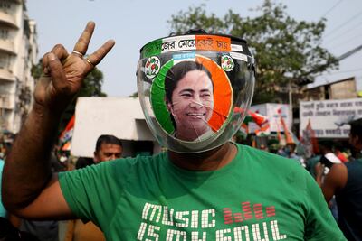 A supporter of the Chief Minister of West Bengal state and the Chief of Trinamool Congress (TMC) Mamata Banerjee, wearing a face shield with her image on it, gestures during celebrations after the initial poll results, amid the spread of coronavirus disease (COVID-19), in Kolkata, India, May 2, 2021. REUTERS/Rupak De Chowdhuri