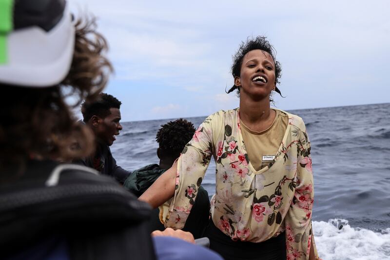 A woman smiles with relief as she sees the rescue team approaching.