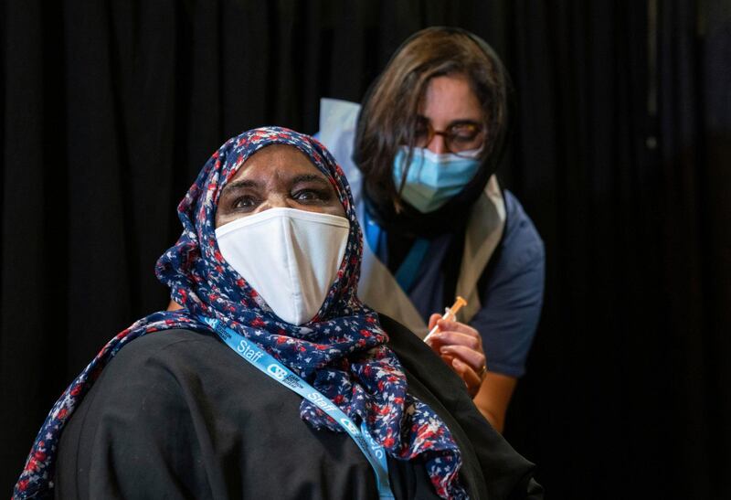 A woman is vaccinated at a Covid-19 pop-up vaccination centre, at the East London Mosque in Whitechapel, London. AP Photo