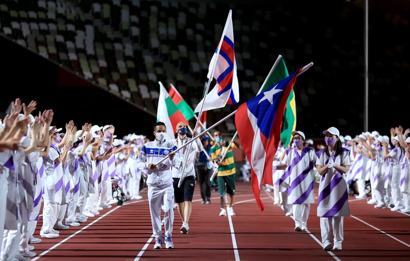 The flag-bearer of Puerto Rico during the closing ceremony. Getty