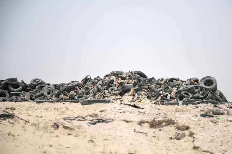 DUBAI, UNITED ARAB EMIRATES - AUGUST 1, 2018. 

Vinu Panicker points at the dumping ground for tyres, opposite his home.

(Photo by Reem Mohammed/The National)

Reporter: Patrick Ryan
Section:  NA