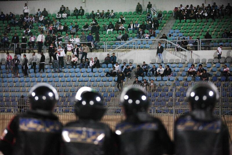 In this Sunday, Feb. 8, 2015 photo, Egyptians watch a match between Egyptian Premier League clubs Zamalek and ENPPI at the Air Defense Stadium in a suburb east of Cairo, Egypt. Egypt's Cabinet has indefinitely suspended the national soccer league after more than 20 fans were killed in a stampede and clashes with police outside the Cairo stadium. (AP Photo/Ahmed Abd El-Gwad, El Shorouk Newspaper) EGYPT OUT