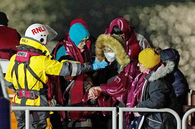 A group of people thought to be migrants are brought to Dover by the RNLI. PA