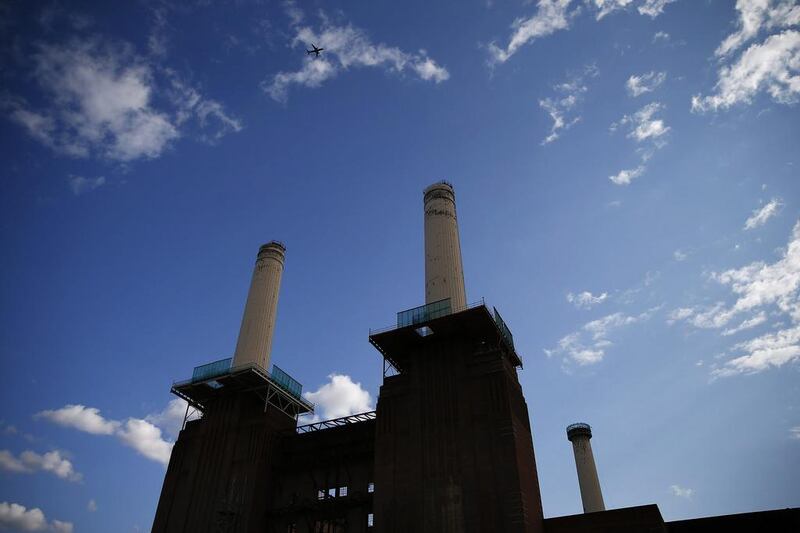 A rig surrounds the top of one of the chimneys of Battersea Power Station. Developers have demolished the art deco landmark's corroded chimney's and will replace them with replicas, as part of the re-development of the area. Andrew Winning / Reuters