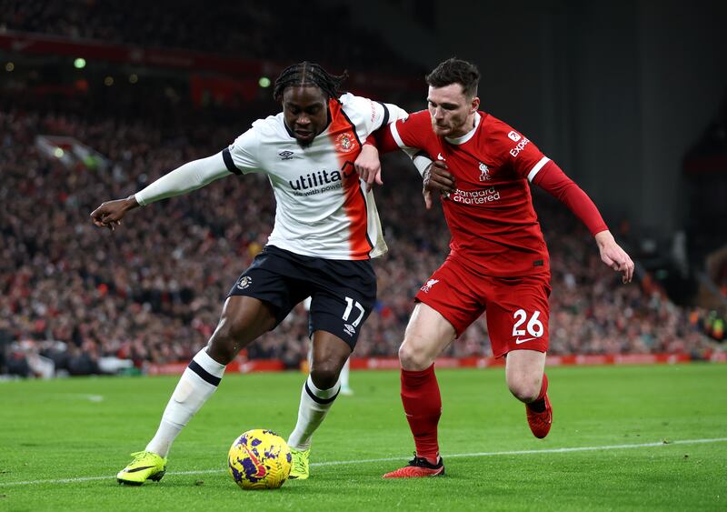 Pelly Ruddock Mpanzu of Luton Town battles for possession with Andrew Robertson of Liverpool. Getty Images