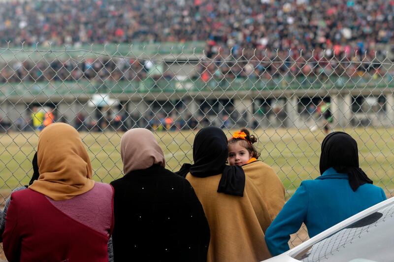 TOPSHOT - Palestinian women watch the football match between Al-Nuseirat and Al-Jalaa standing outside the fence of the stadium at Nuseirat refugee camp, south of Gaza City, on January 28, 2018.
Police blocked dozens of women from attending the football match, in what activists said they hoped would have been the first such permission under Hamas's rule. / AFP PHOTO / MAHMUD HAMS