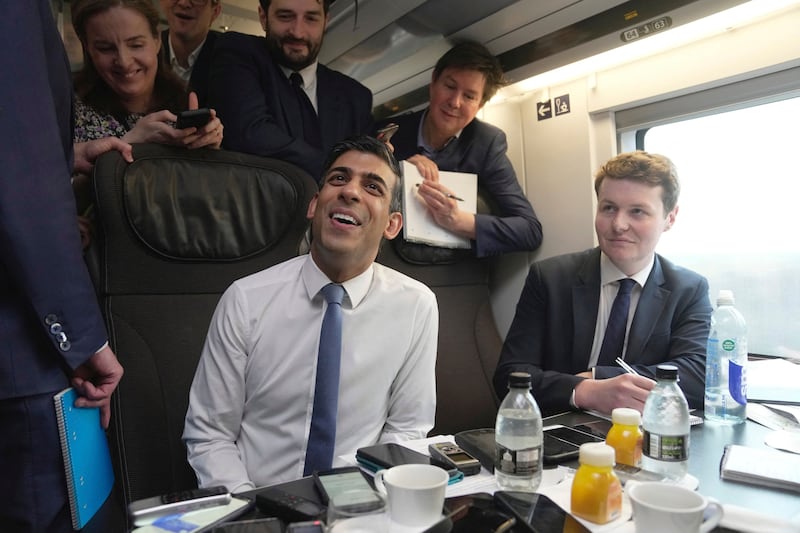 Mr Sunak speaks to the press during his train journey from London to Paris. AFP