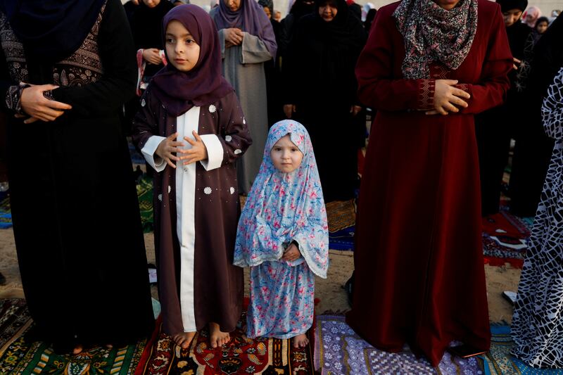 Palestinian girls perform morning prayers to celebrate Eid al-Fitr, marking the end of the holy fasting month of Ramadan, in Khan Younis, in the southern Gaza Strip. Reuters