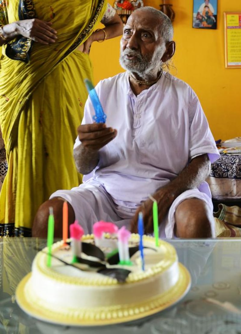 Indian monk Swami Sivananda reacts after his followers presented him with a birthday cake in Kolkata.