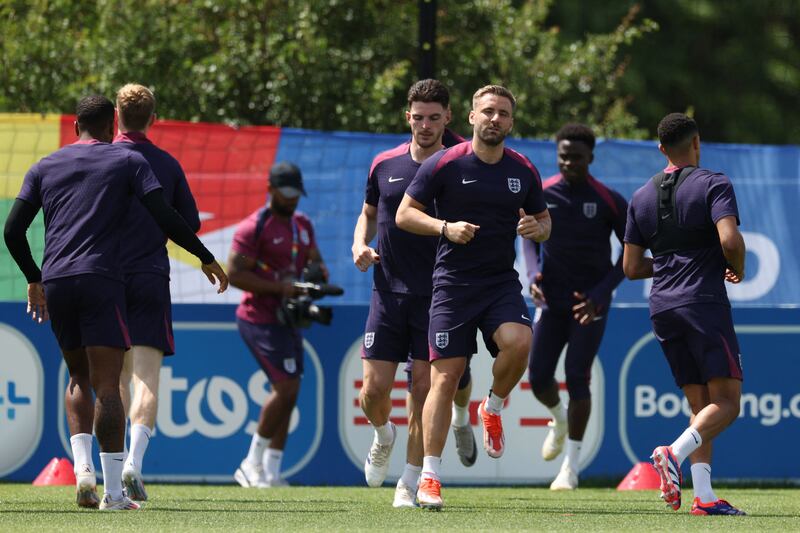 England's Declan Rice and Luke Shaw training with teammates on the eve of their Euro 2024 Group C match against Slovenia.  AFP