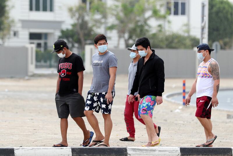 Dubai, United Arab Emirates - Reporter: N/A: People walk through Al Barsha with face masks. Monday, March 30th, 2020. Dubai. Chris Whiteoak / The National