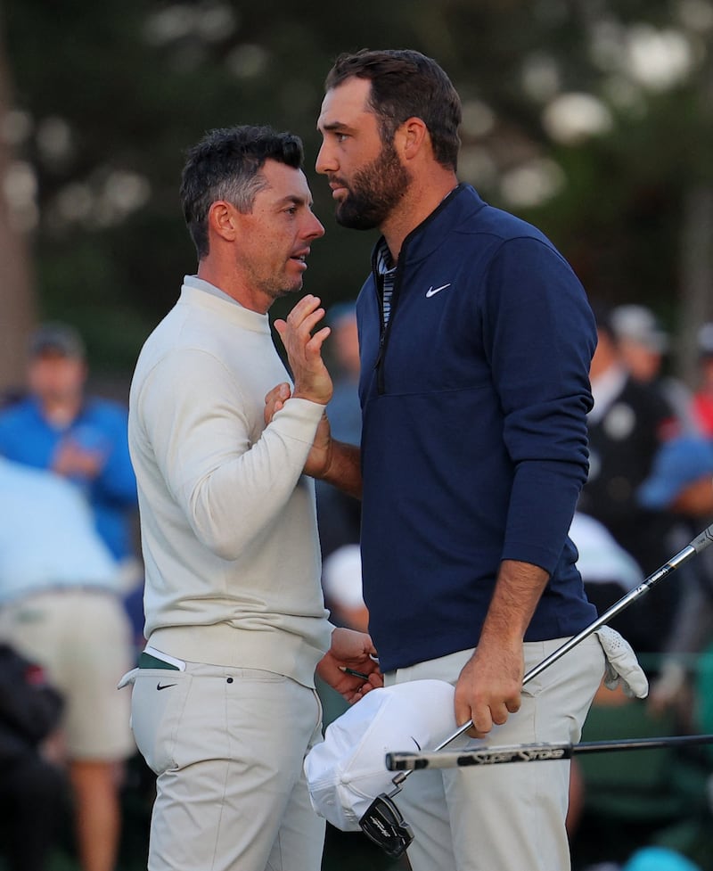 Scottie Scheffler shakes hands with Rory McIlroy after completing their second round. Reuters