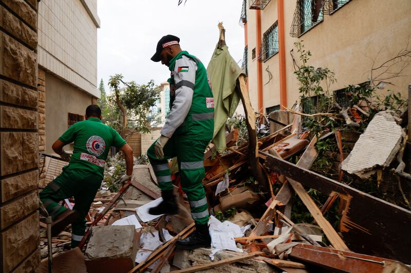 Rescuers pick through debris in the aftermath of the strikes. Reuters