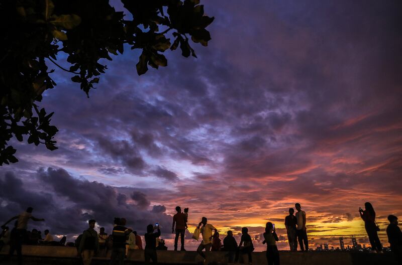A spectacular sunset on Marine Drive promenade as monsoon clouds hover over the Arabian Sea shore in Mumbai, India. EPA 