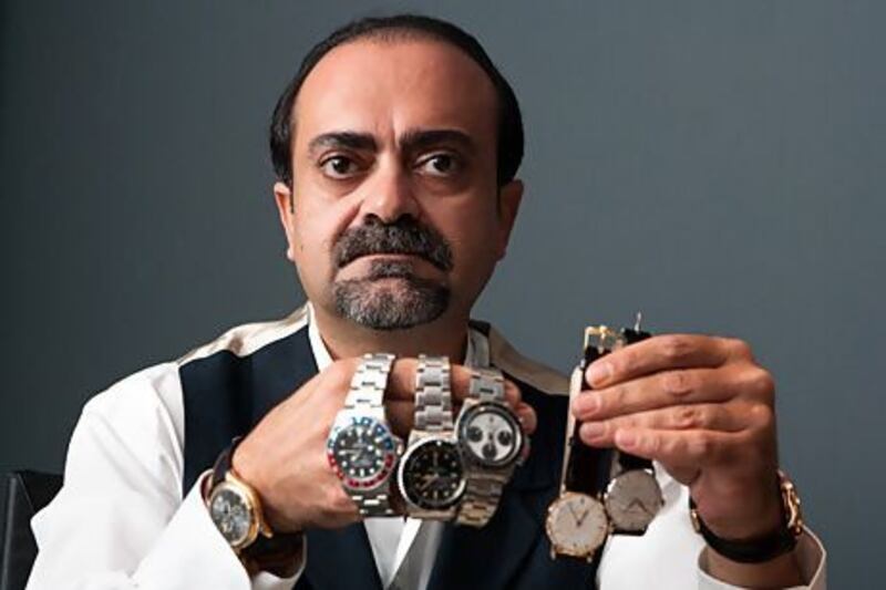 Joe Haj Ali displays some examples from his vintage watch collection. Duncan Chard for The National