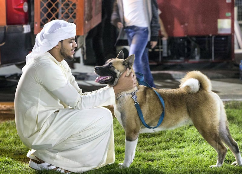 ABU DHABI, UNITED ARAB EMIRATES, 28 OCTOBER 2018 - Pet owner with his dog at the inaugural of Yas Pet Together event at Yas Du Arena, Abu Dhabi.  Leslie Pableo for The National for Evelyn Lau's story