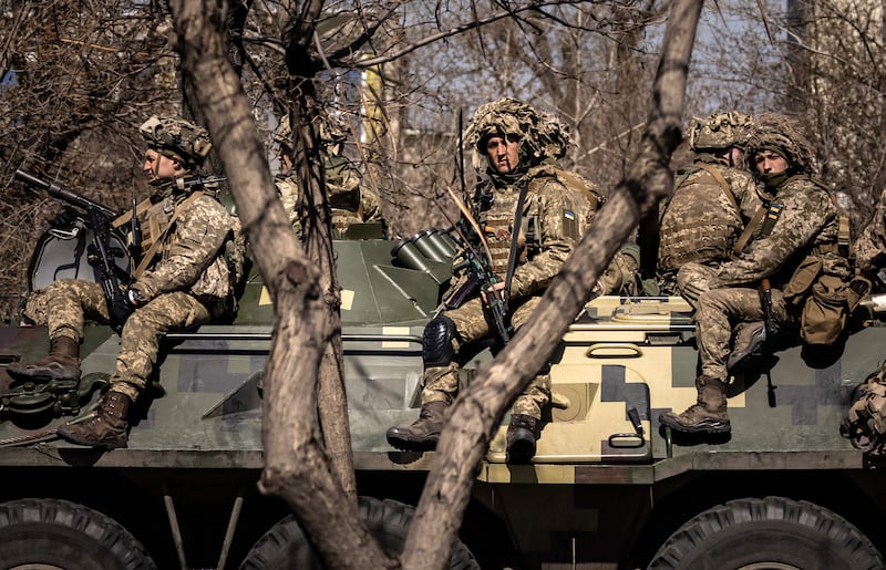 Ukrainian soldiers sit on an armoured military vehicle in the city of Severodonetsk, Donbass region. AFP