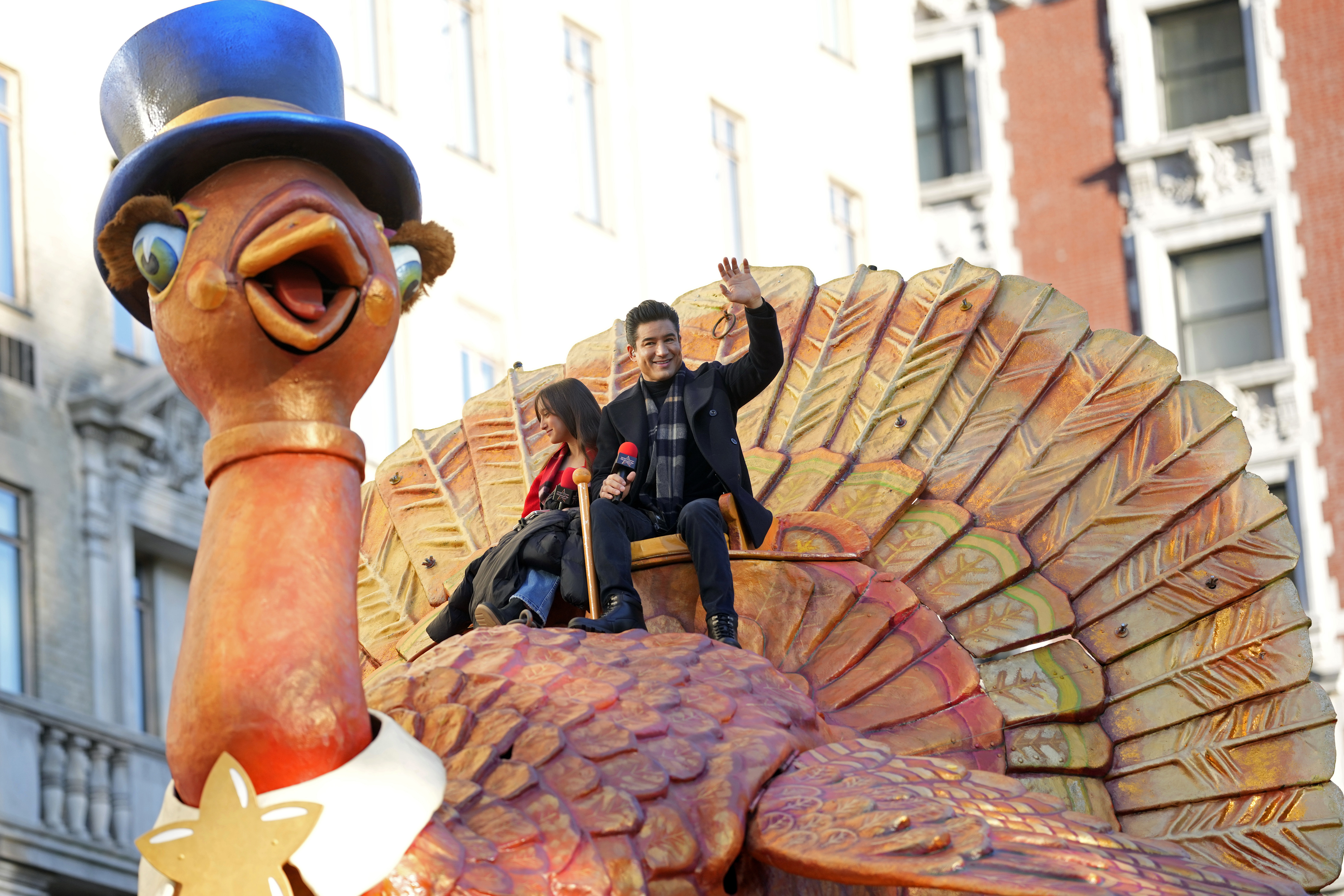 Gia Lopez and Mario Lopez ride the Tom Turkey float. AP