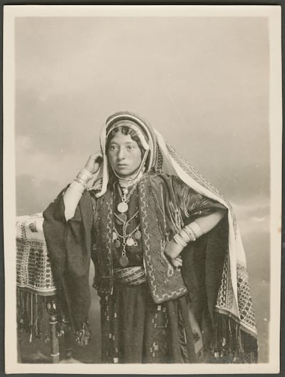 A studio portrait of a woman. The text on the reverse side reads "Ramallah girl". Gail O'Keefe Edson. Courtesy of Akkasah Centre for Photography