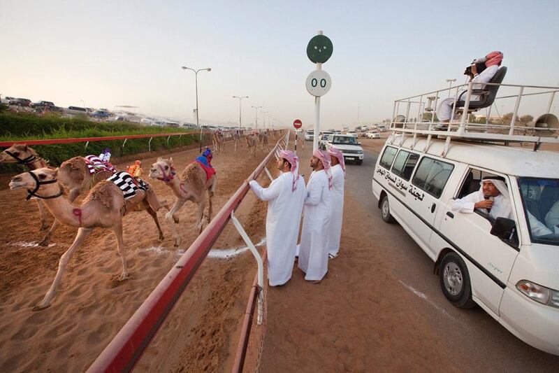 Ras Al Khaimah, United Arab Emirates, Jun 09, 2012 -  Judges, a commentator and a camera man, watch the finish line during an early morning camel race at RAK camel race track. ( Jaime Puebla / The National Newspaper ) For summer series weathering it 
