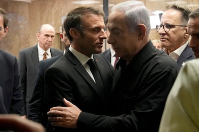 Israeli Prime Minister Benjamin Netanyahu and French President Emmanuel Macron embrace following a joint press conference in Jerusalem in October 2023. Reuters