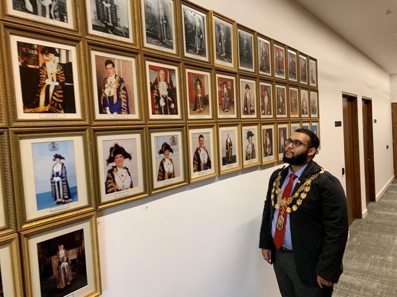 Lord Mayor of Westminster Hamza Taouzzale looks at photos of his predecessors. Photo: Westminster City Council