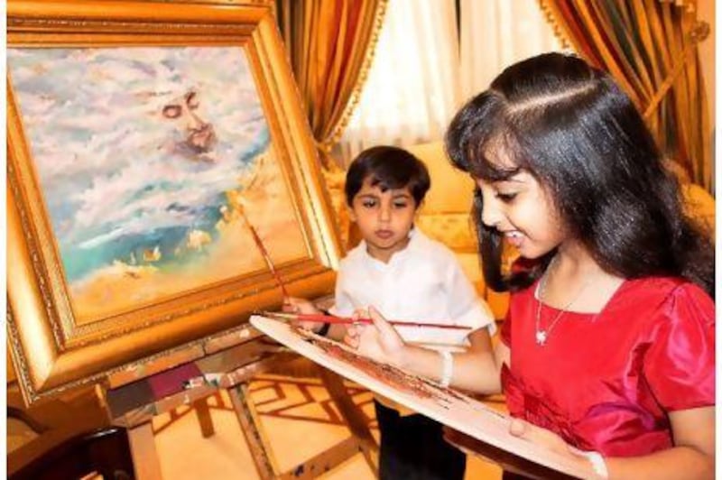 Sheikha Sheikha, along with her brother Sheikh Mohammed, help their mother Sheikha Alyazia bint Nahyan Al Nahyan in painting artworks.