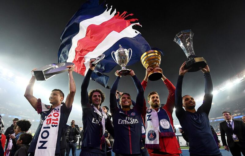Paris Saint-Germain's Julian Draxler, Adrien Rabiot, Thiago Silva, Kevin Trapp and Layvin Kurzawa celebrate with a trophy after winning the French L1 title at the Parc des Princes stadium in Paris.   Franck Fife / AFP
