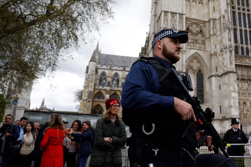 Police officers patrol near Westminster Abbey as security is heightened for the coronation. AFP