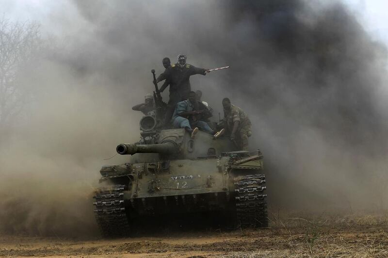 Sudanese Armed Forces (SAF) and Rapid Support Forces (RSF) personnel ride on a tank after recapturing the Daldako area, outside the military headquarters in Kadogli. Mohamed Nureldin Abdallah / Reuters
