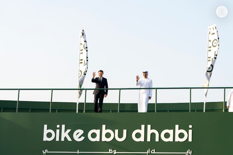 Sheikh Khaled waves from an overpass at a ceremony in which Abu Dhabi received the UCI Bike City label.