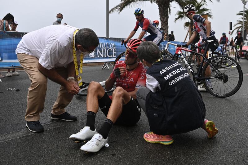 Team Arkea - Samsic rider Kevin Ledanois is checked by medics after falling. AFP