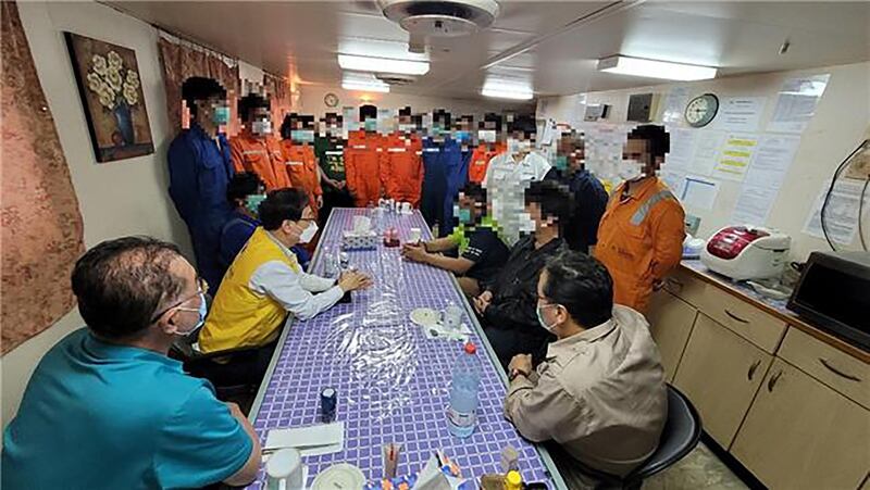 This handout photo taken on February 3, 2021 and provided by South Korean Foreign Ministry on February 4, 2021 shows a South Korean official (centre L - yellow vest) meeting with crew members of the Hankuk Chemi, a tanker seized by Iran, on the ship in Iran.  - RESTRICTED TO EDITORIAL USE - MANDATORY CREDIT "AFP PHOTO / South Korean Foreign Ministry" - NO MARKETING NO ADVERTISING CAMPAIGNS - DISTRIBUTED AS A SERVICE TO CLIENTS
Faces were blurred by the provider due to privacy concerns
 / AFP / South Korean Foreign Ministry / Handout / RESTRICTED TO EDITORIAL USE - MANDATORY CREDIT "AFP PHOTO / South Korean Foreign Ministry" - NO MARKETING NO ADVERTISING CAMPAIGNS - DISTRIBUTED AS A SERVICE TO CLIENTS
Faces were blurred by the provider due to privacy concerns
