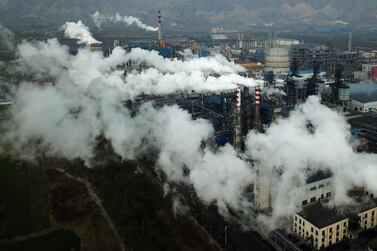 Smoke and steam rise from a coal processing plant in Hejin in central China's Shanxi Province in 2019. The Covid-19 pandemic has proved an unlikely push for green transition amid falling emissions from halted air and ground travel. AP