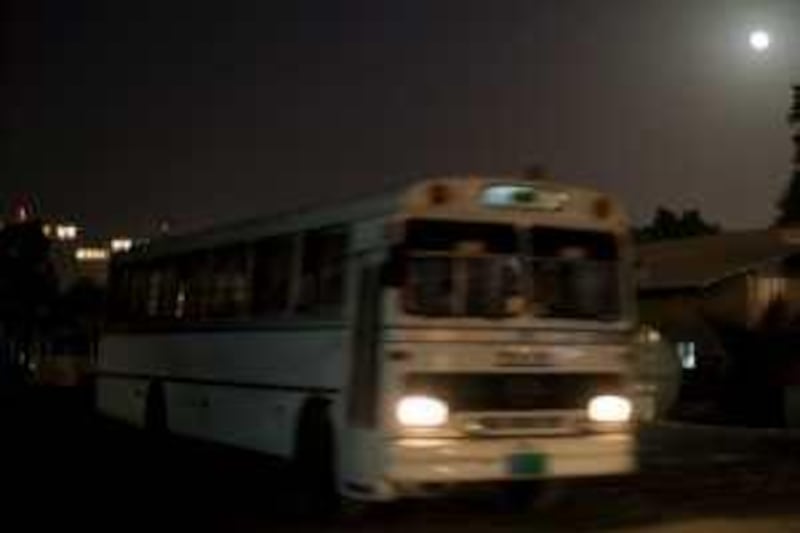 Abu Dhabi - July 17, 2008. A bus drives out of the ETA labour camp in Mussafah. ( Philip Cheung / The National ) *** Local Caption ***  PC0027-ETAlabourcamp.JPGPC0027-ETAlabourcamp.JPG