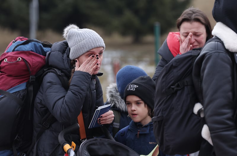 Distraught women and children fleeing Ukraine wait to enter Poland at the Korczowa crossing. Getty