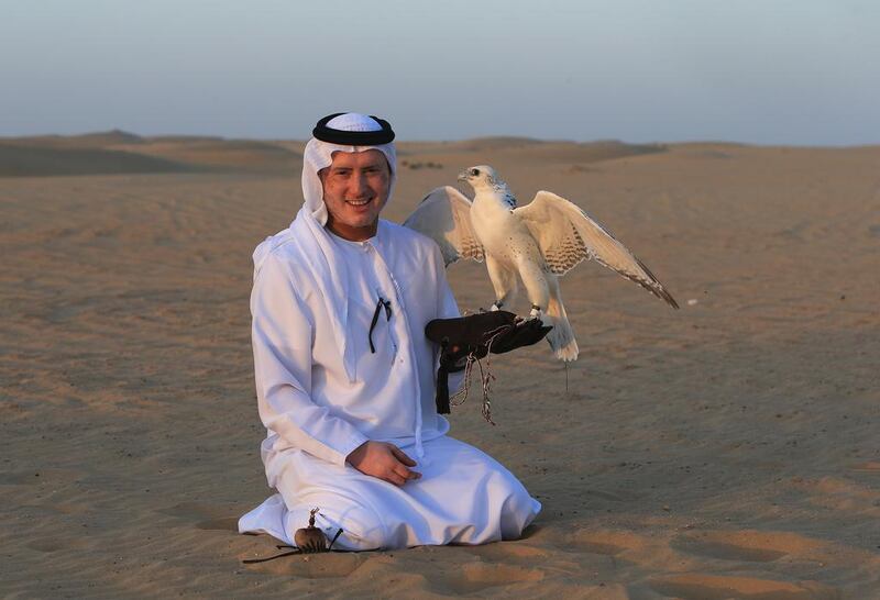 Salem Al Dhabari with one of his prize-winning falcons. His birds have been bought for more than Dh100,000 each. Ravindranath K / The National