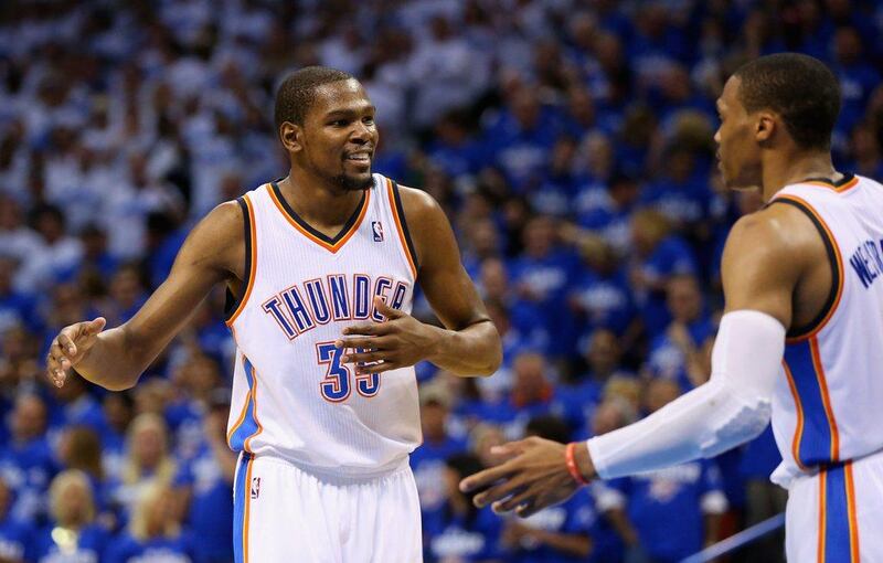 Kevin Durant and Russell Westbrook react during Oklahoma City's Game 4 win over San Antonio on Tuesday night. Ronald Martinez / Getty Images / AFP / May 27, 2014 
