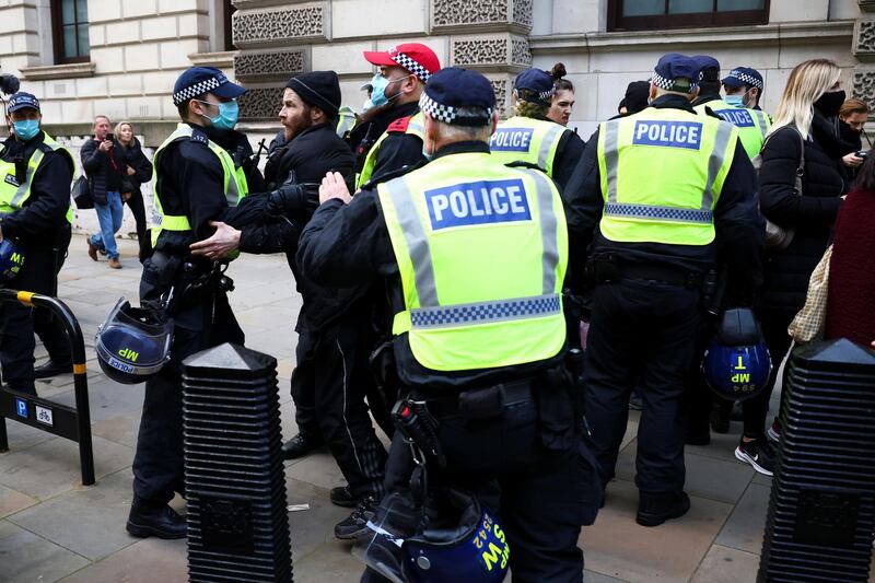 Police officers detain anti-lockdown protestors during a demonstration amid the coronavirus disease (COVID-19) outbreak in London,.  Reuters